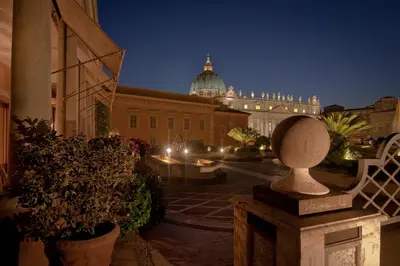 a view of a city at night with a building at Residenza Paolo VI in Rome