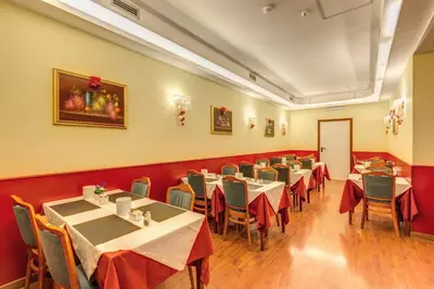 a restaurant with tables and chairs in a room at Hotel Impero in Rome
