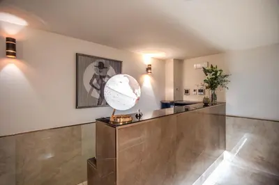 a lobby with a large globe on a counter at Hotel San Silvestro in Rome