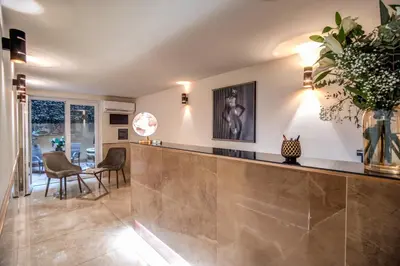 a lobby with a counter with a vase of flowers at Hotel San Silvestro in Rome