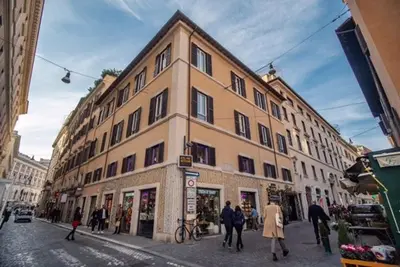a large building on a city street with people walking around at Hotel San Silvestro in Rome