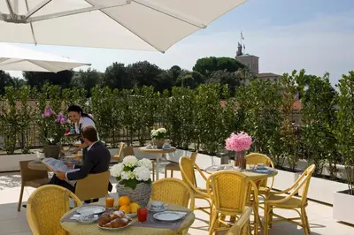a couple sitting at a table on a patio at Hotel De Petris in Rome