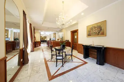 a living room with a table and a dining room at Hotel Traiano in Rome