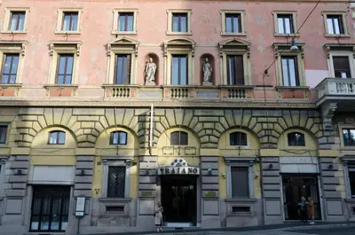 a building with statues on the side of it at Hotel Traiano in Rome