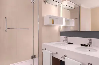 a bathroom with a shower and a toilet and a sink at Le Meridien Visconti Rome in Rome