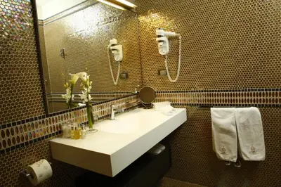 a bathroom with a sink and a mirror at Augustana House and Suites in Rome
