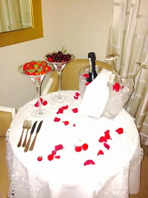 a table with a white table cloth with red hearts on it at Augustana House and Suites in Rome