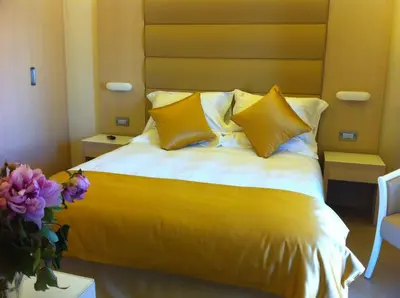 a yellow bed with yellow pillows in a room at Augustana House and Suites in Rome