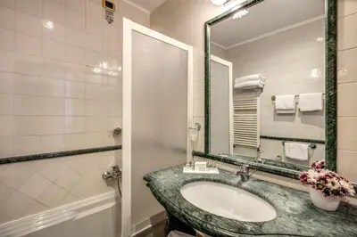 a bathroom with a sink and a mirror at Hotel Villafranca in Rome
