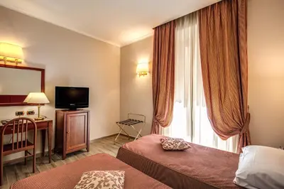 a hotel room with a bed and a television at Hotel Villafranca in Rome
