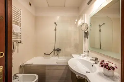 a bathroom with a sink and a tub and a toilet at Hotel Villafranca in Rome