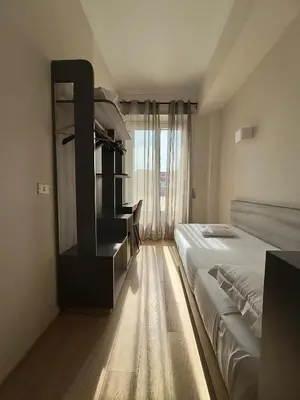 a bedroom with two beds and a large window at Hotel Laura in Rome
