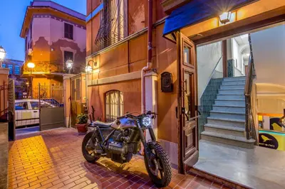 a motorcycle parked on the side of a building at Free Hostels Roma in Rome