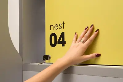 a woman with her hand on a yellow wall at Free Hostels Roma in Rome