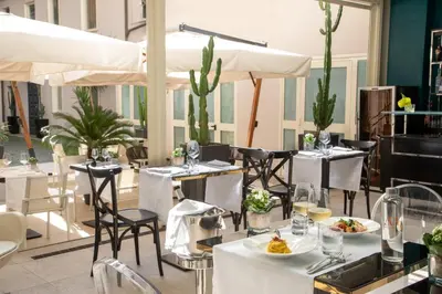 a restaurant with tables and chairs with food on them at The Guardian in Rome