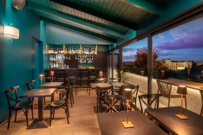 a restaurant with tables and chairs and a bar at The Guardian in Rome