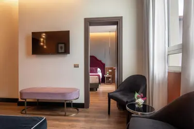 a living room with a couch and chairs and a mirror at The Guardian in Rome