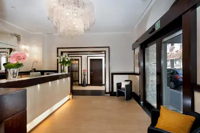 a lobby with a reception desk and a chandelier at Yes Hotel Boutique Rome in Rome