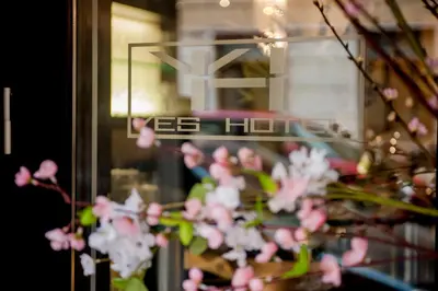 a bunch of pink flowers in front of a window at Yes Hotel Boutique Rome in Rome