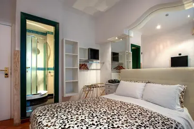 a bedroom with a large bed in a room at Hotel Canova in Rome