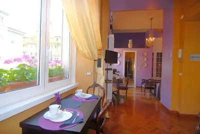 a dining room with a table with dishes on it at Suite Casa Pariolina in Rome