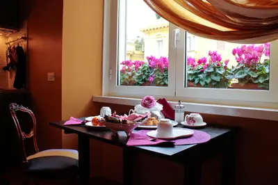a table with food on it in front of a window at Suite Casa Pariolina in Rome