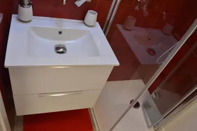 a bathroom with a white sink and a shower at Posada de Liz y Fabrizio in Rome