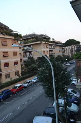 a street light with cars parked in a parking lot at Posada de Liz y Fabrizio in Rome