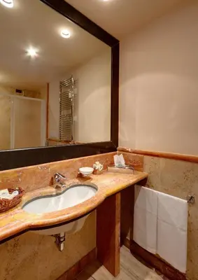 a bathroom with a sink and a mirror at Residenza RomaCentro in Rome