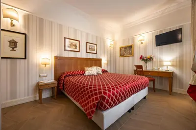 a bedroom with a bed with a red comforter at Residenza RomaCentro in Rome