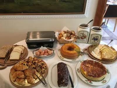 a table full of different types of bread and pastries at Residenza RomaCentro in Rome