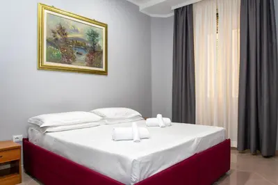 a bed in a room with a painting on the wall at Hotel Philia in Rome