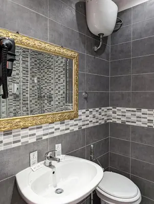 a bathroom with a sink and a toilet and a mirror at Hotel Philia in Rome