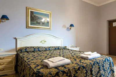 a bedroom with a bed with two towels on it at Hotel Philia in Rome