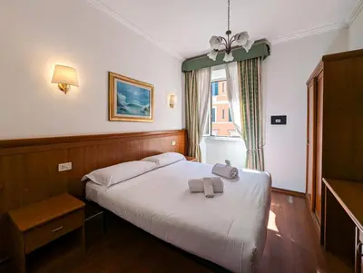 a bedroom with a bed with two towels on it at Hotel Philia in Rome