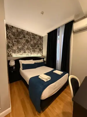 a bedroom with a bed with two towels on it at Relais Fontana Di Trevi Hotel in Rome