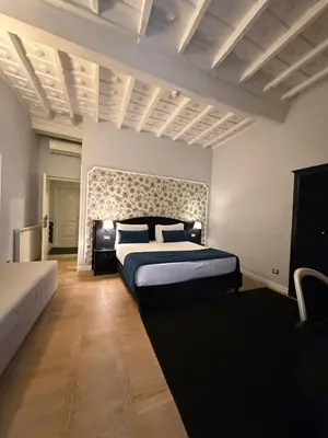 a bedroom with a king sized bed and a large wall at Relais Fontana Di Trevi Hotel in Rome