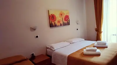 a hotel room with two beds with towels on them at Hotel Everest in Rome