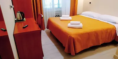 a bedroom with a bed with two towels on it at Hotel Everest in Rome