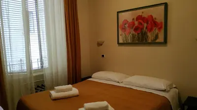 a bedroom with a bed with two towels on it at Hotel Everest in Rome