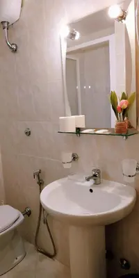a bathroom with a sink and a mirror and a toilet at Hotel Everest in Rome