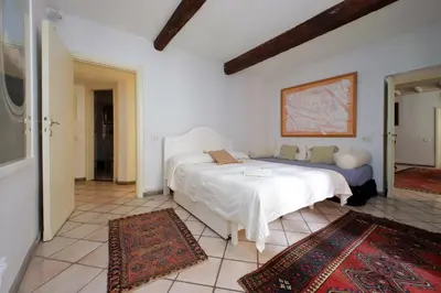 a bedroom with two beds in a room with rugs at Sangallo Charme in Rome