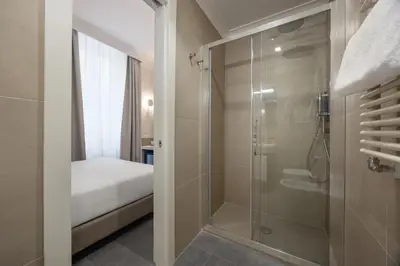 a small room with a bed and a window at Hotel Astoria Garden in Rome
