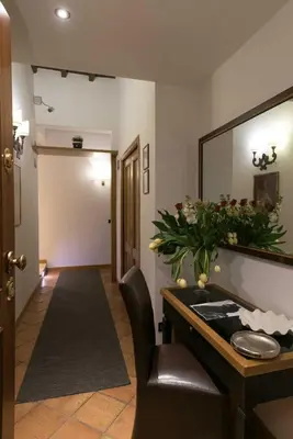 a waiting room with a mirror and a chair at Duca d'Alba Hotel - Chateaux & Hotels Collection in Rome