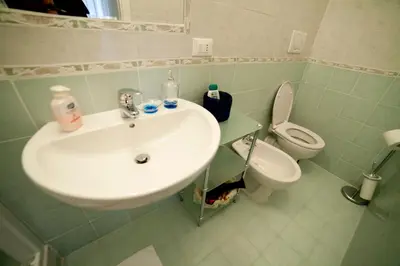 a bathroom with a sink and a toilet at Suite Argentina in Rome
