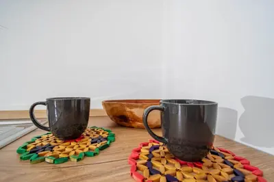 two coffee mugs sitting on top of a wooden table at La Casa dei Sogni di Serena in Rome