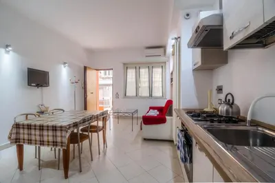 a kitchen with a sink and a table with chairs at La Casa dei Sogni di Serena in Rome