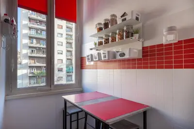 a red bench in a room with two windows at B&B Easy in Rome