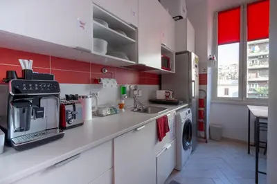 a kitchen with a sink and a washing machine at B&B Easy in Rome