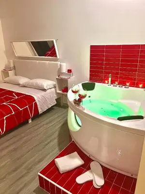 a bathroom with a bath tub and a bed at B&B Easy in Rome